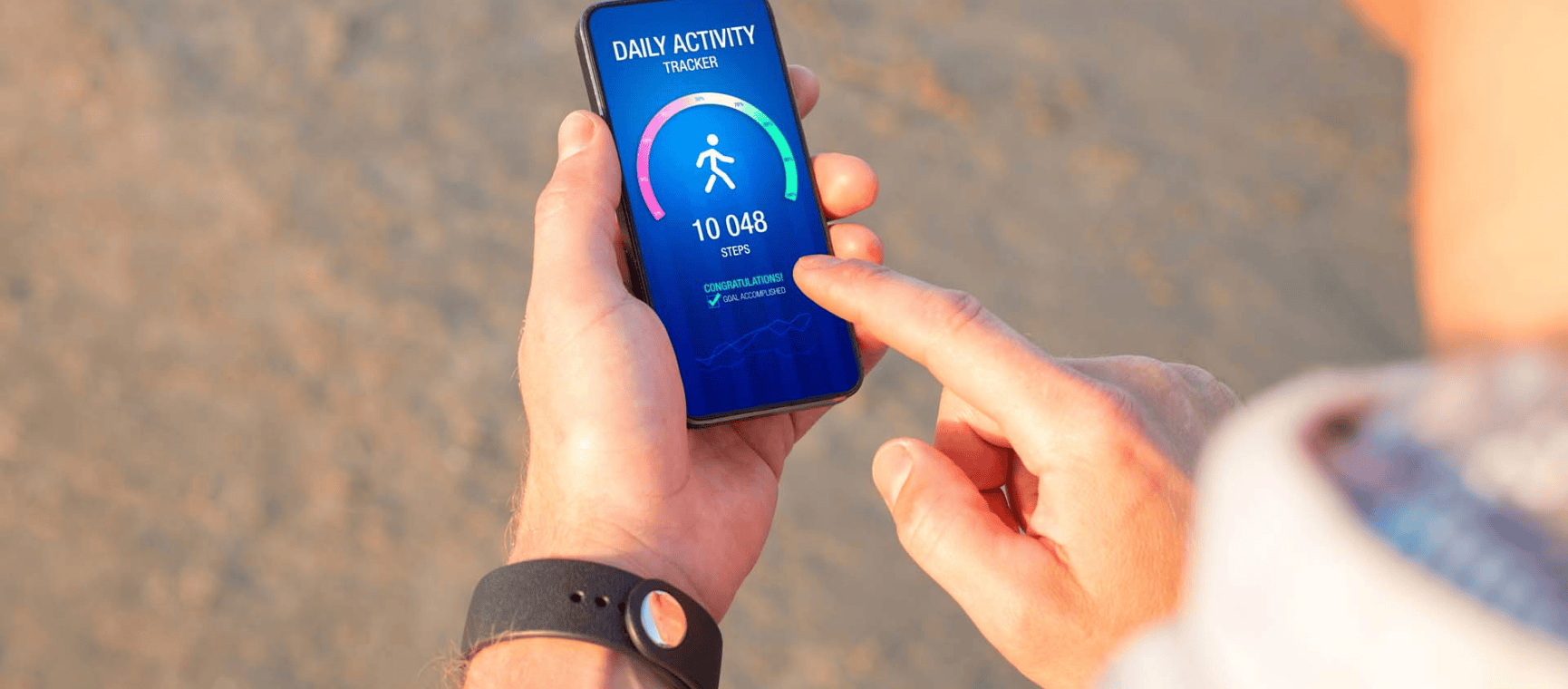 A man holding a mobile phone with a step counting app on it
