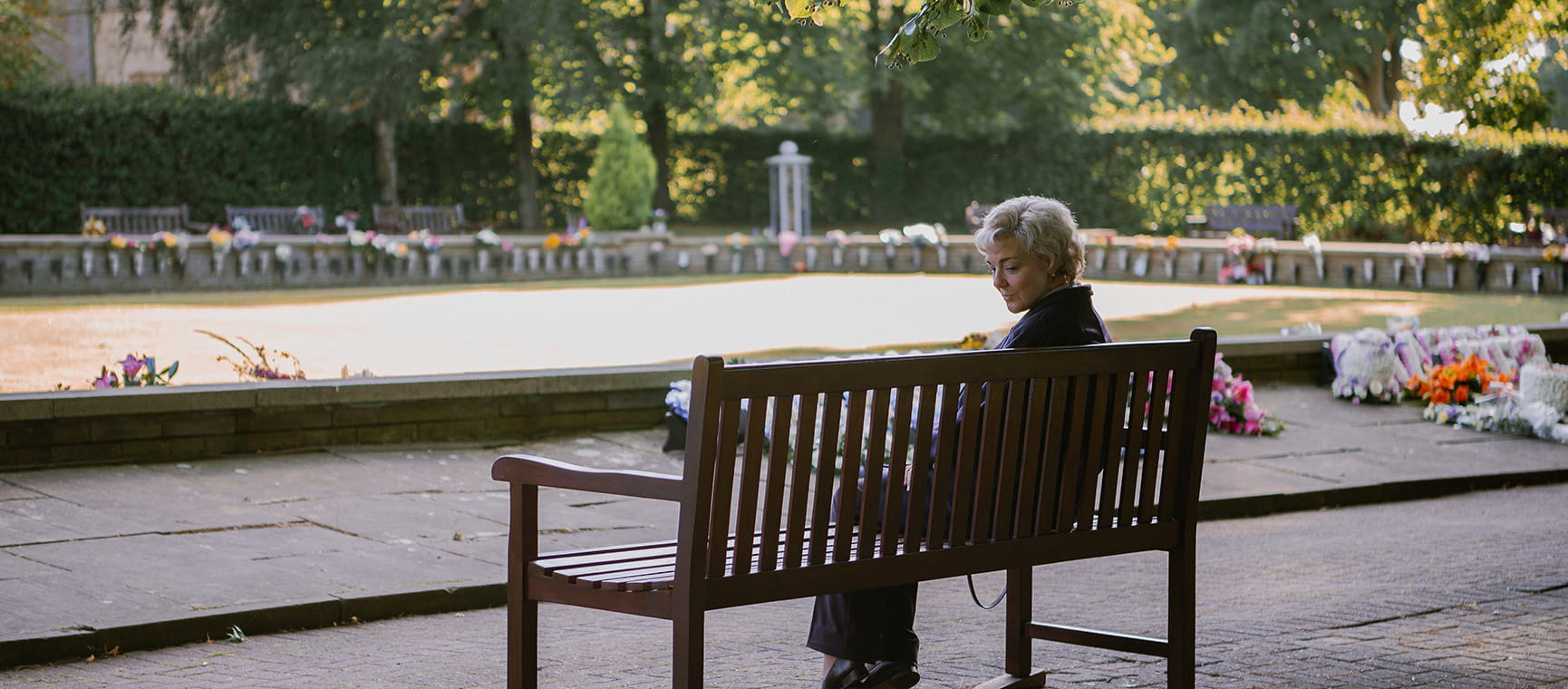 Ann Ming the campaigner being portrayed in the new ITV series sat on a bench