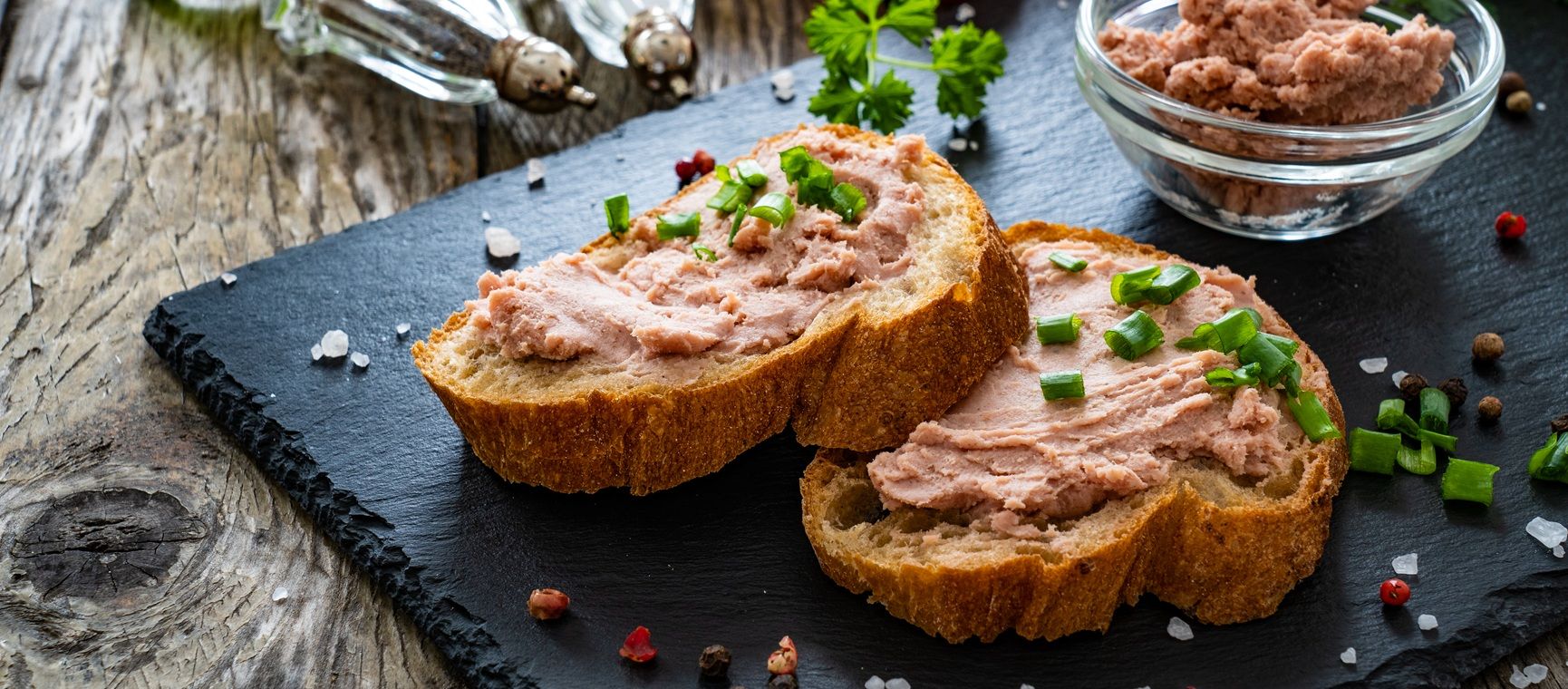 Slices of rustic brown loaf with pâté spread on top