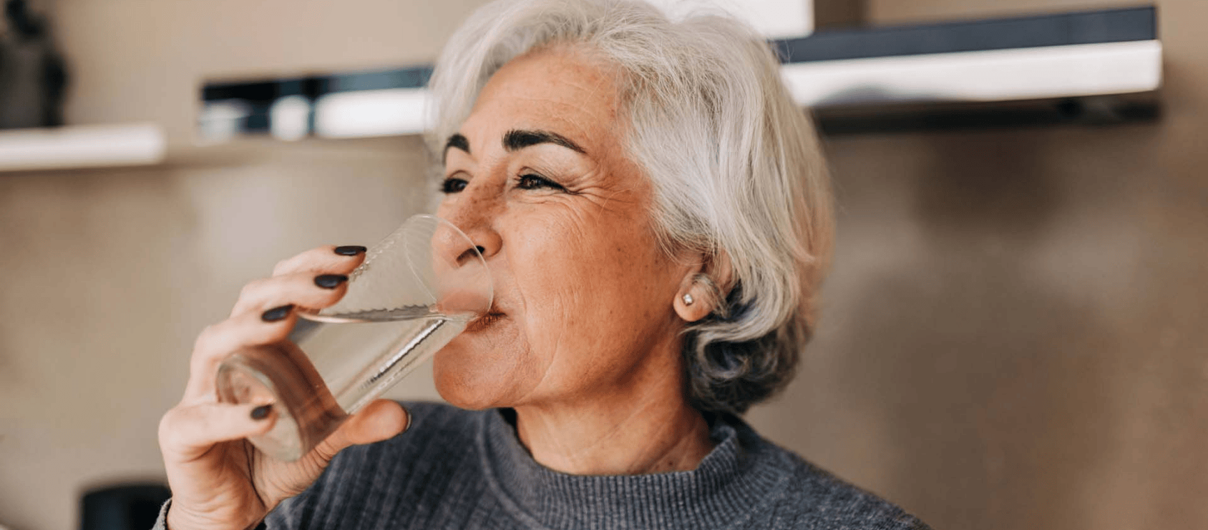 a woman drinking a glass of water