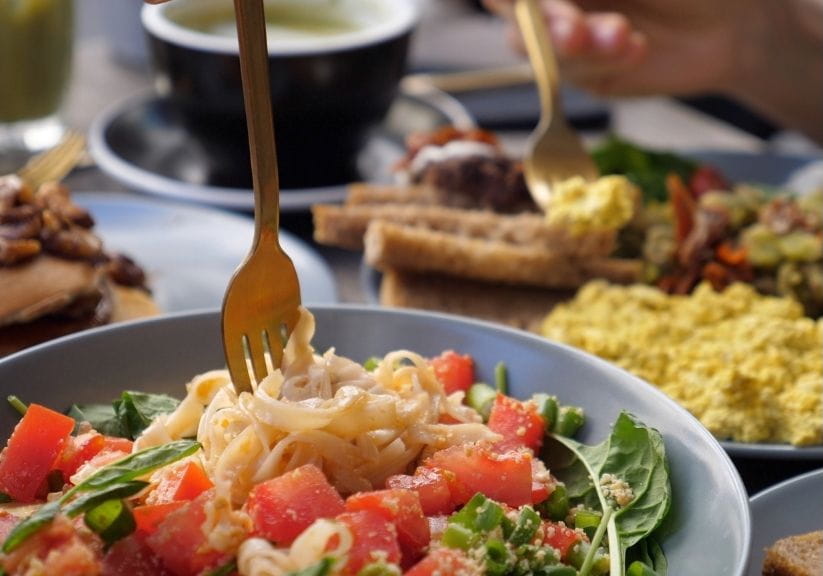 a selection of healthy meals on plates on a wooden table top