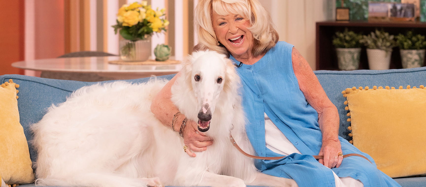 Lynda La Plante with a dog on a sofa