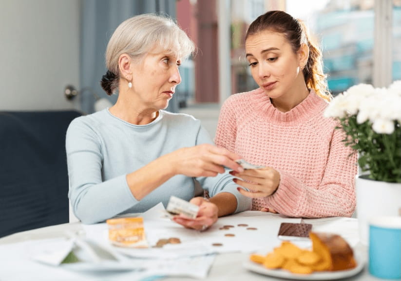 an older mum giving her grown up daughter money