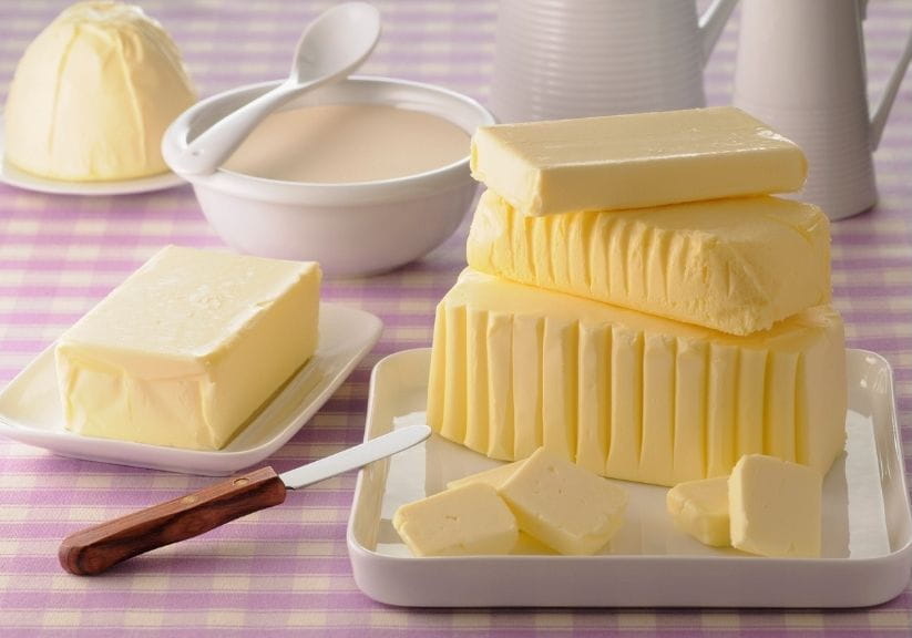 A selection of different butters on a red and white tablecloth