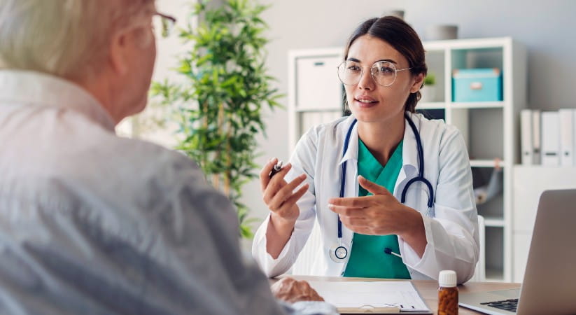 A female GP talking to an older man