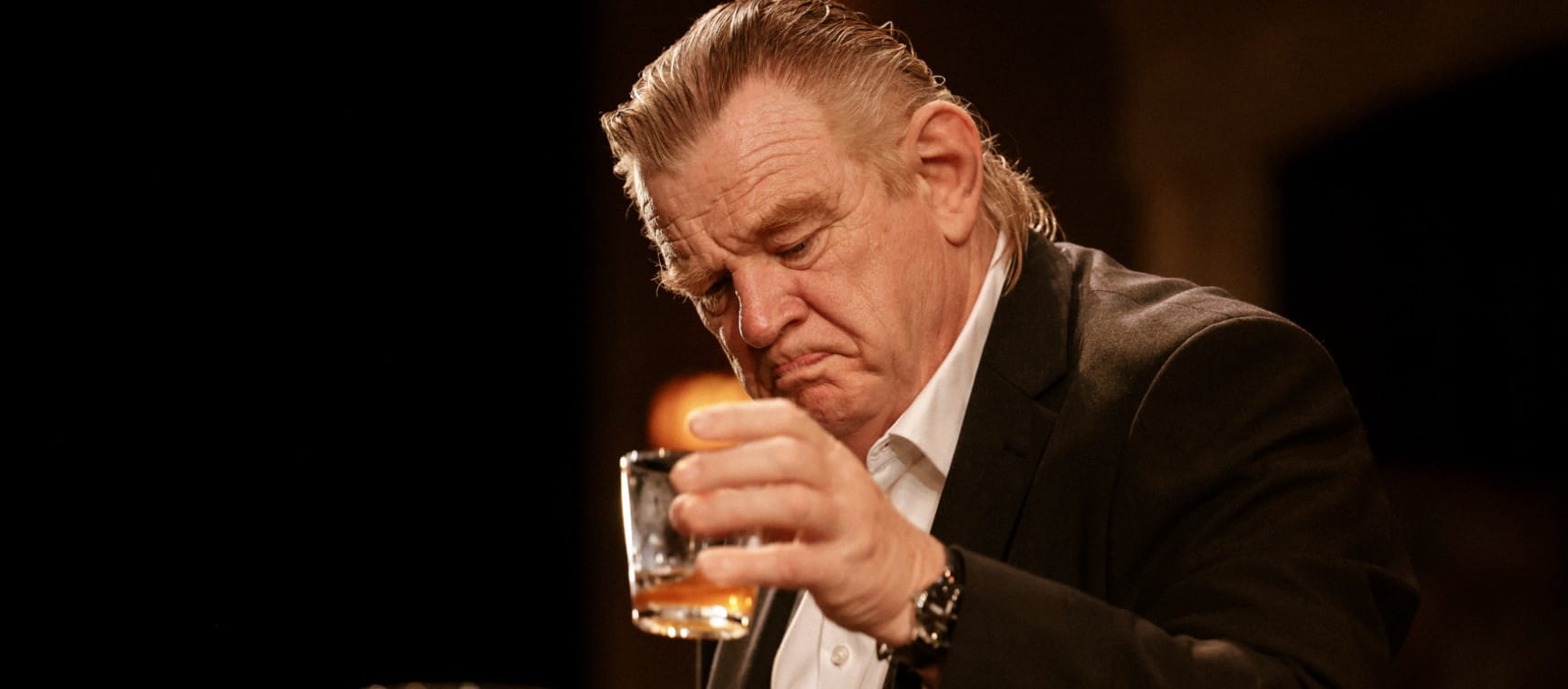 Brendan Gleeson drinking a glass of whiskey in new play The Weir