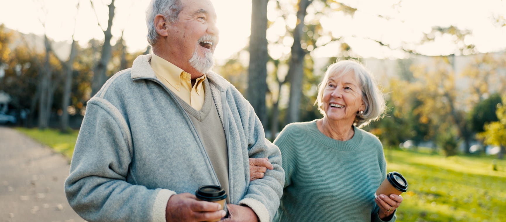 Couple walking and smiling with coffee