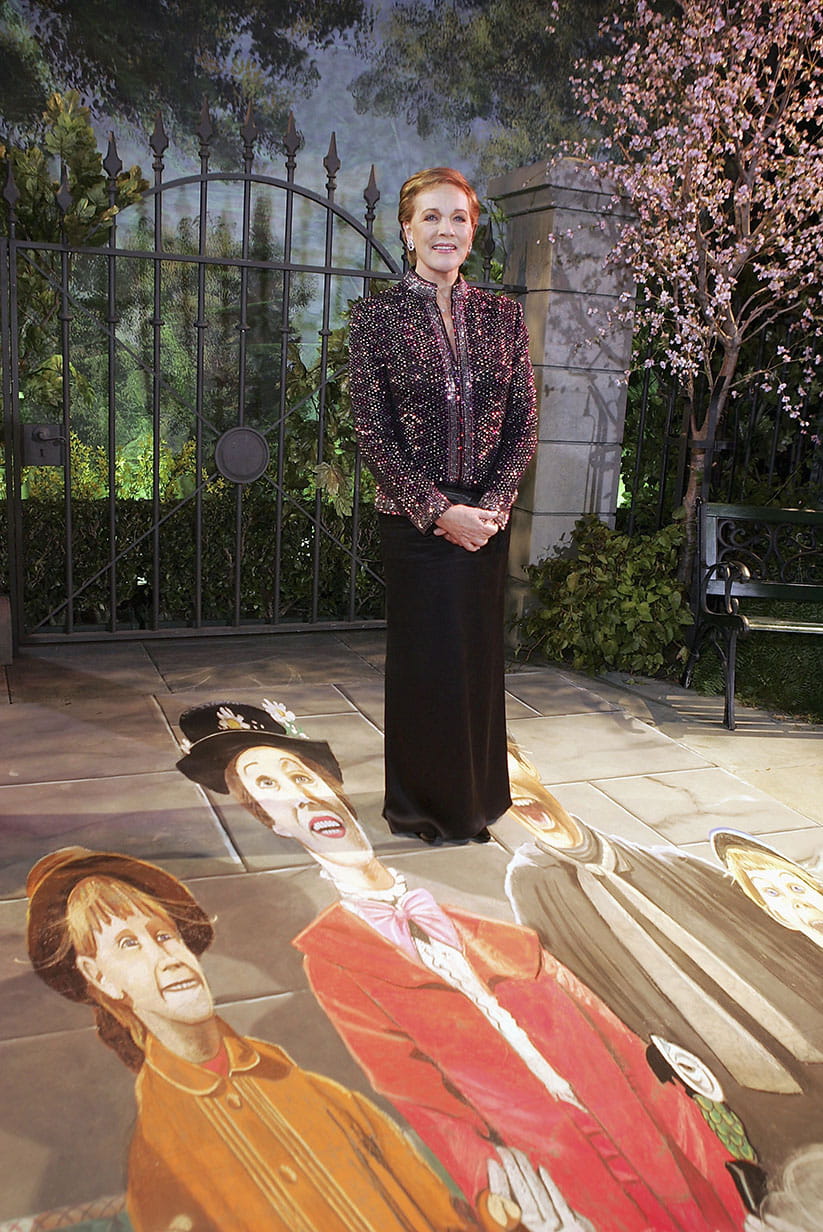 Julie Andrews standing with holograms from the original Mary Poppins