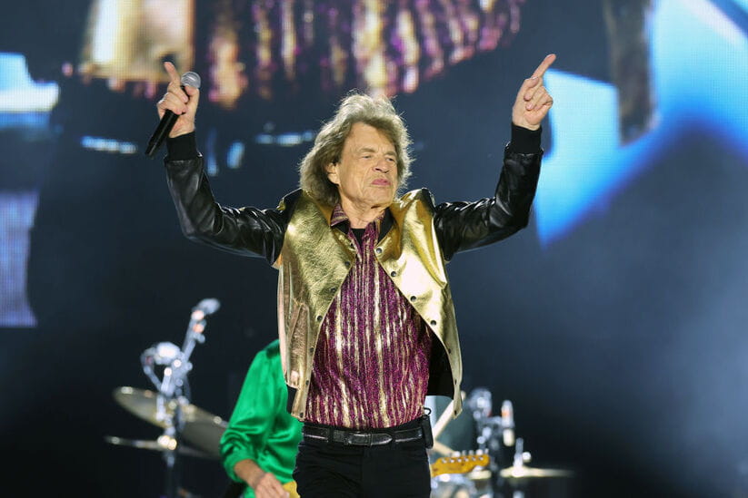 Mick Jagger of The Rolling Stones stands on stage in New Jersey with his arms in the air