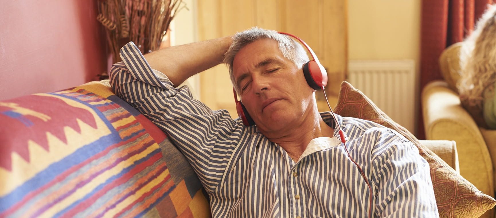 A man napping while wearing headphones
