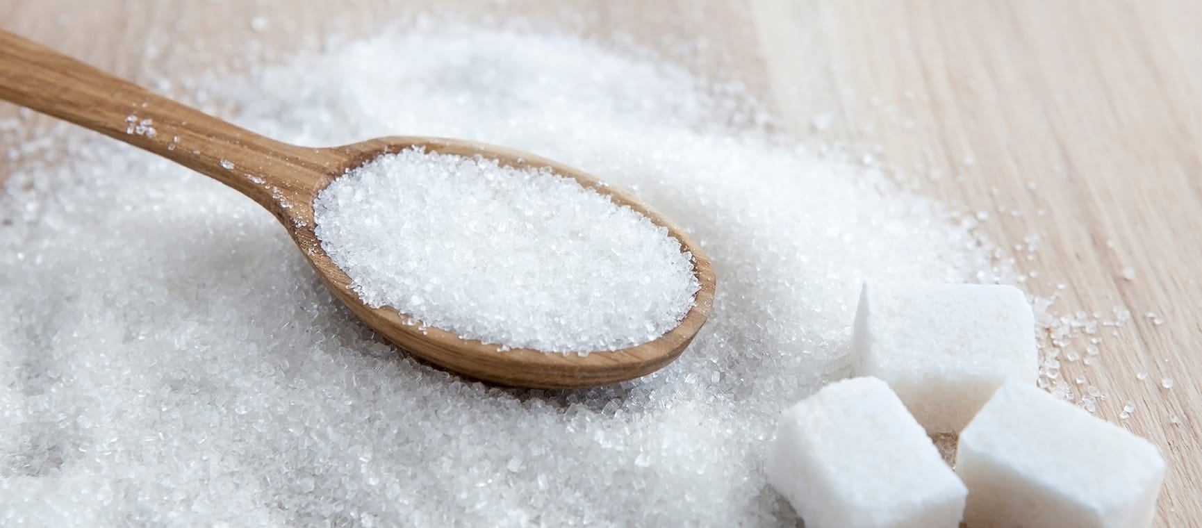 A wooden spoon in sugar
