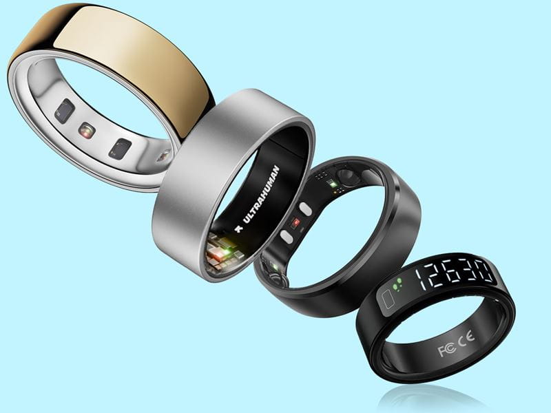 Four smart rings against a pale blue background