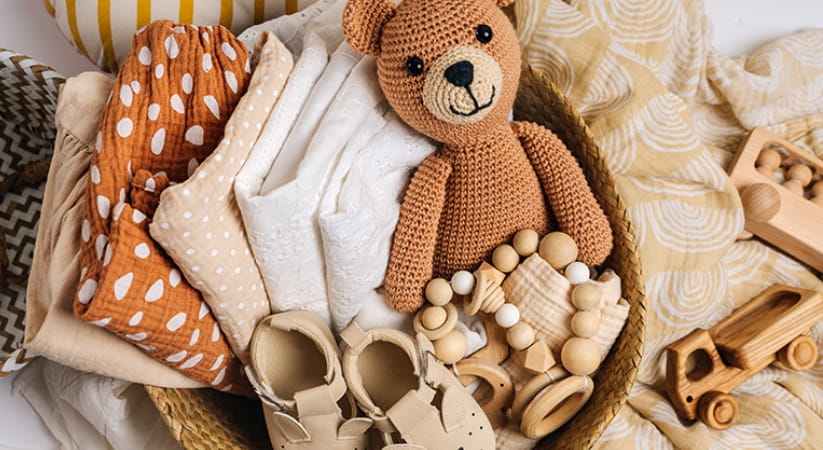A pile of baby clothes and toys