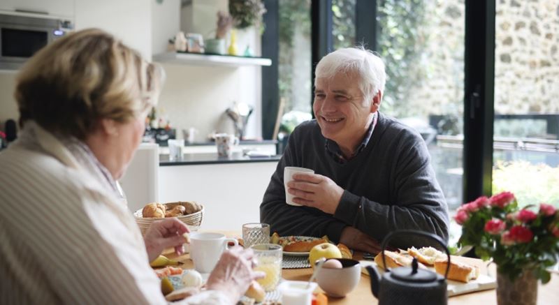 An older couple enjoying breakfast together