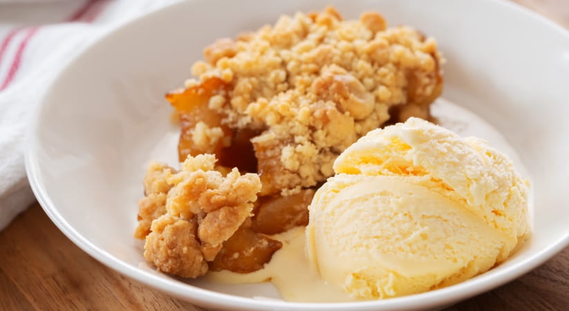 Bowl of apple crumble and ice cream