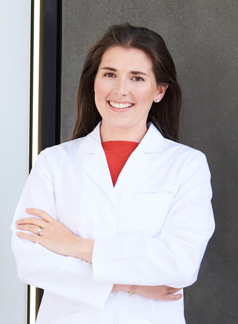 Dr Nichola Conlan standing with her arms crossed