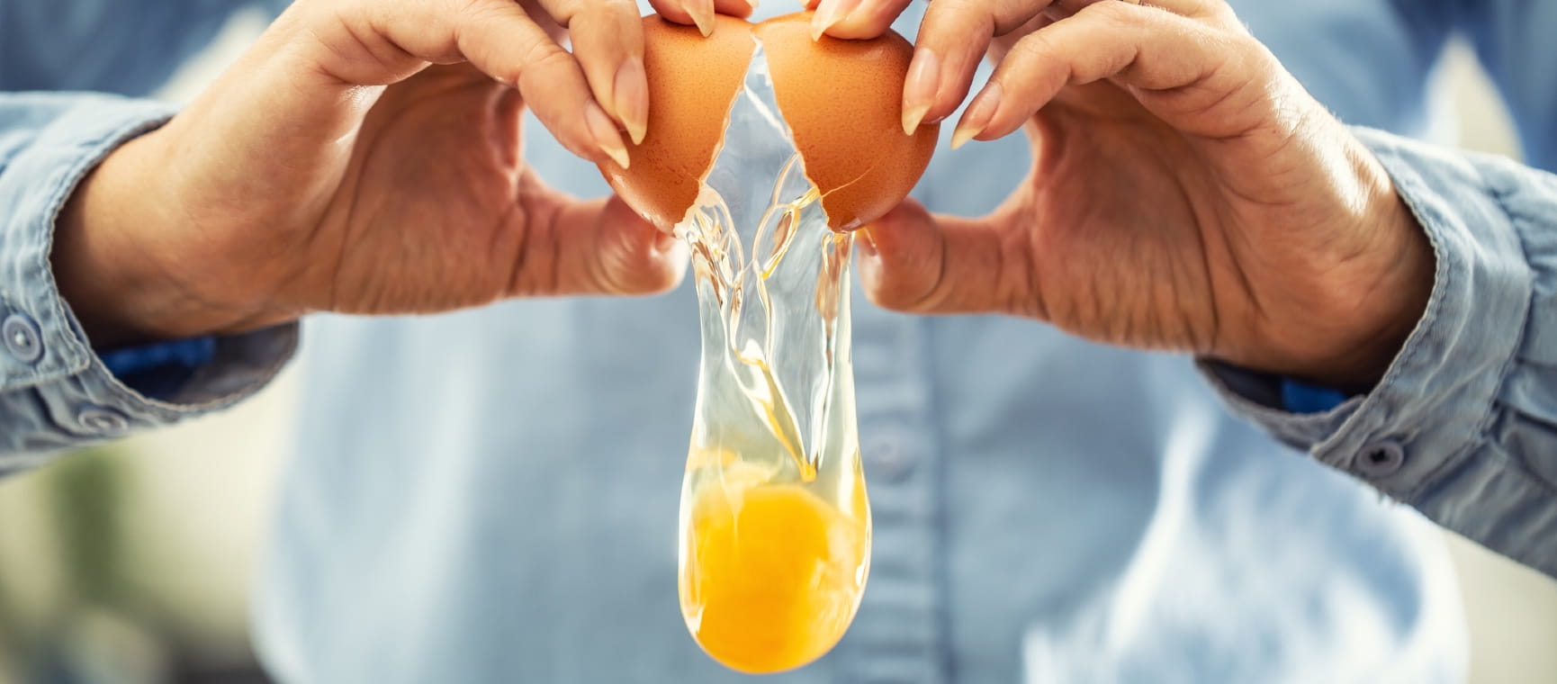 Person breaking an egg