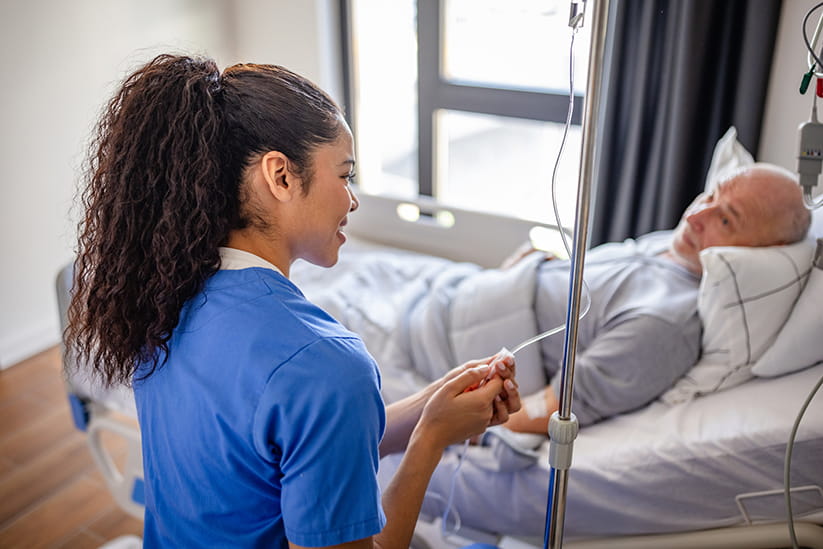 A nurse checking the IV of an older patient