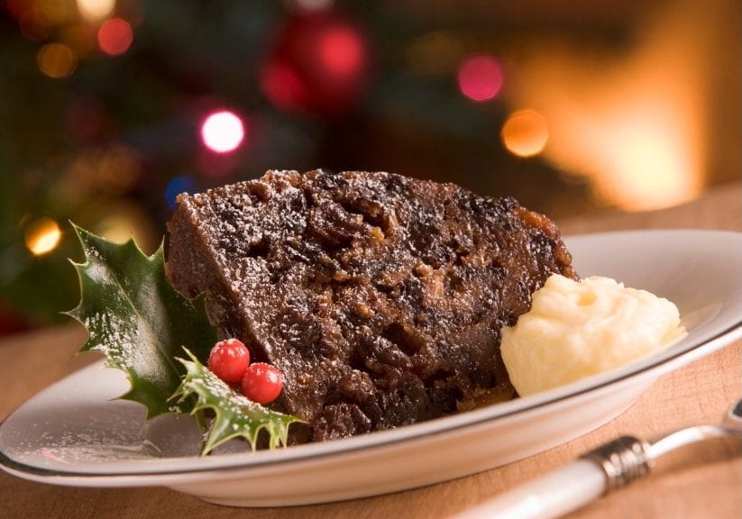 a portion of Christmas pudding with brandy butter