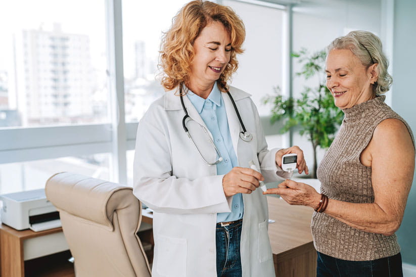 Doctor measuring senior patient's diabetes