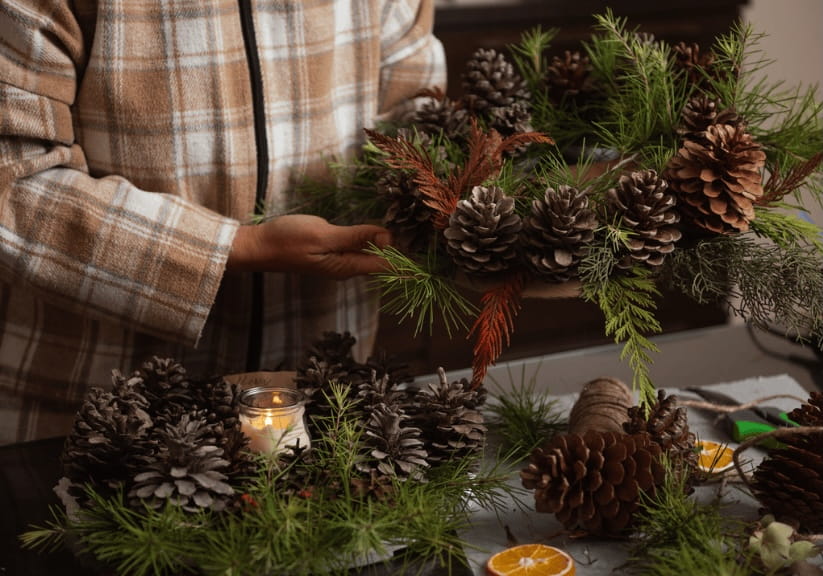 a man making Christmas wreaths from foraged plants