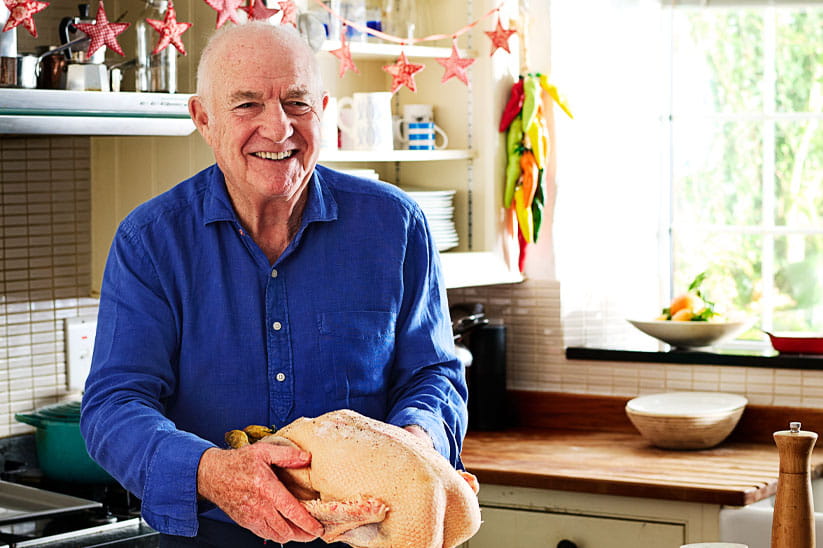 Rick Stein preparing an uncooked turkey