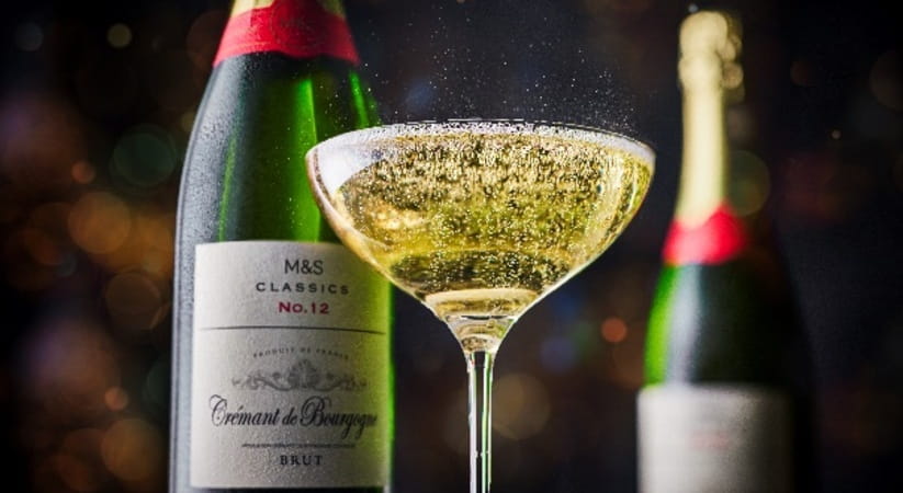 Two M and S champagne bottles with a glass of champagne