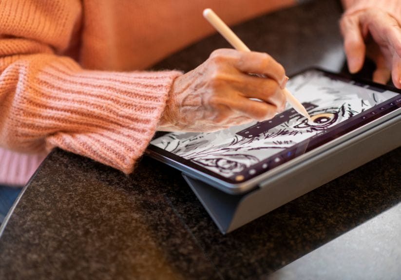 A woman using a computer pad for drawing