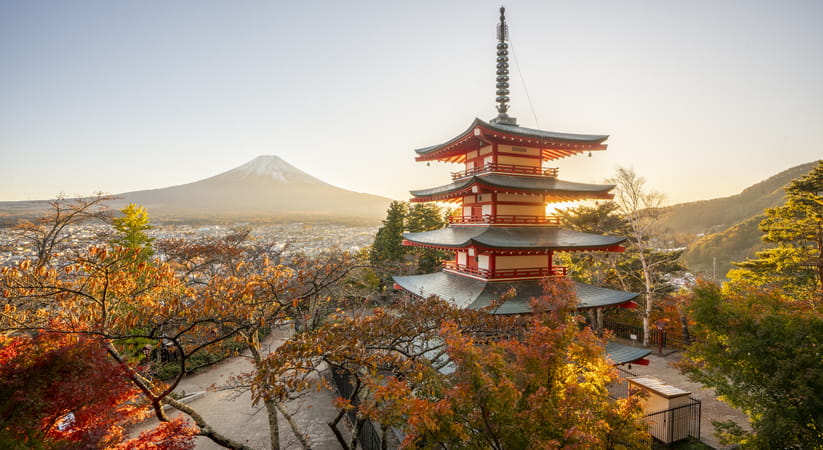 View of a temple in Japan with Mount Fuji in the background