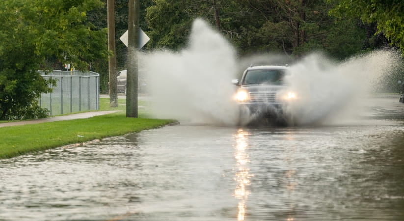 A car driving through severe flooding