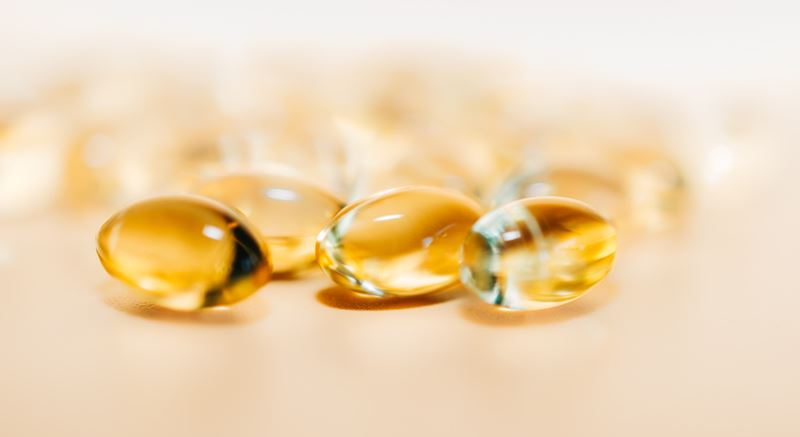 Close-up of some yellow vitamin capsules