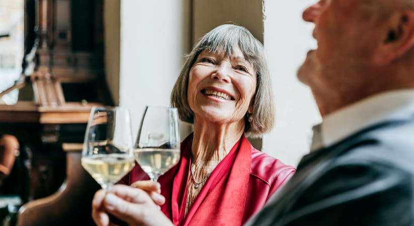 Older couple drinking wine and laughing