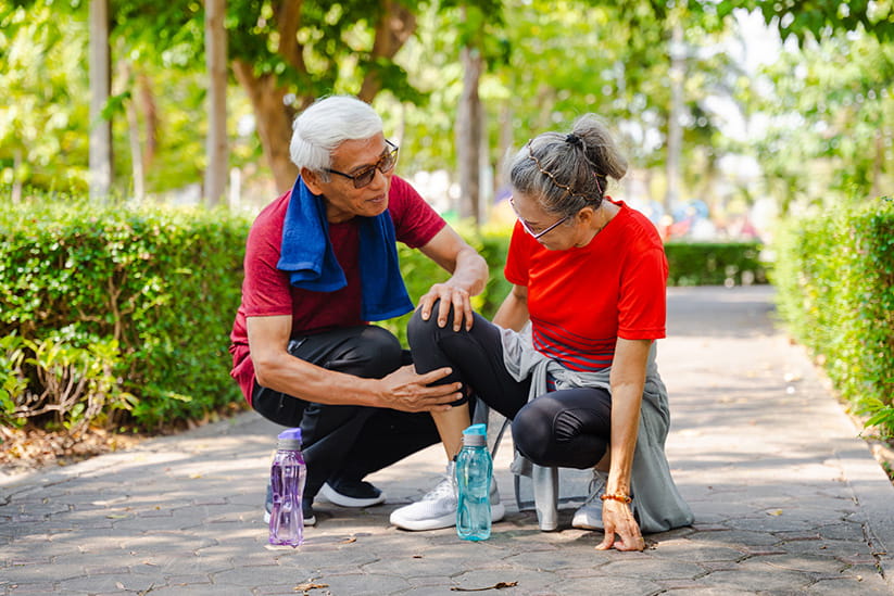 Senior couple with an injured knee after walking the park