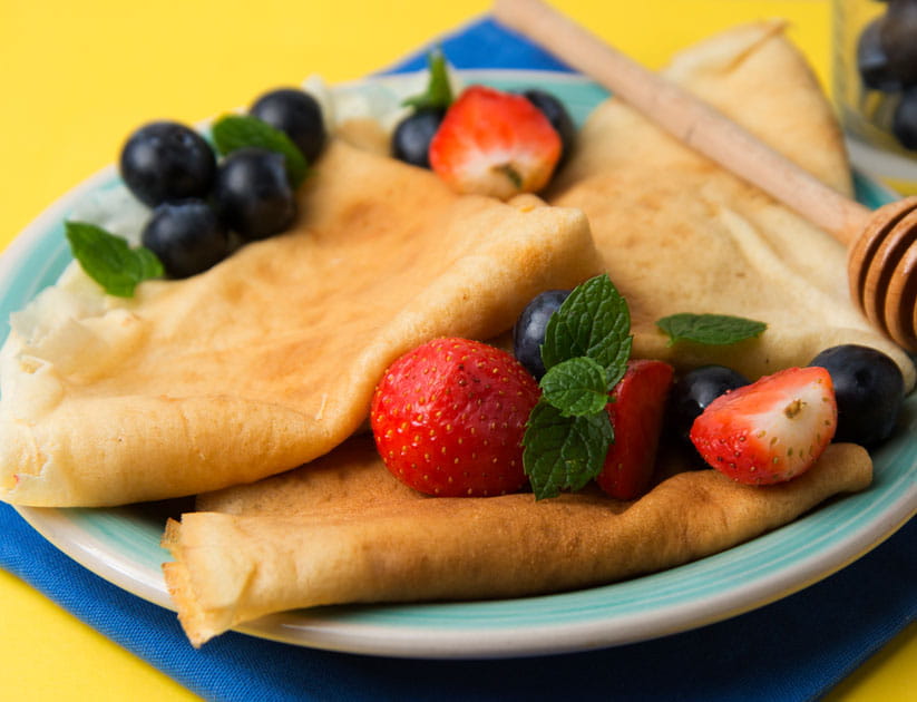 Delicious homemade pancakes, crepes on a plate with berries.