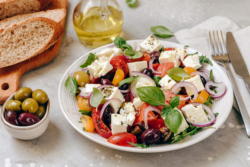 A Mediterranean -style meal with various vegetables and cheeses