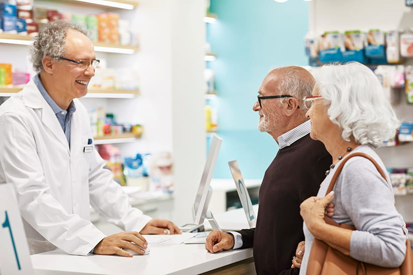 An older couple chatting with a Pharmacist