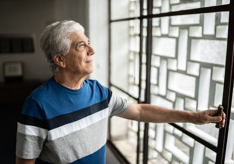 A man is closing a window