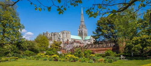 Chichester Cathedral and gardens seen from afar on a sunny day