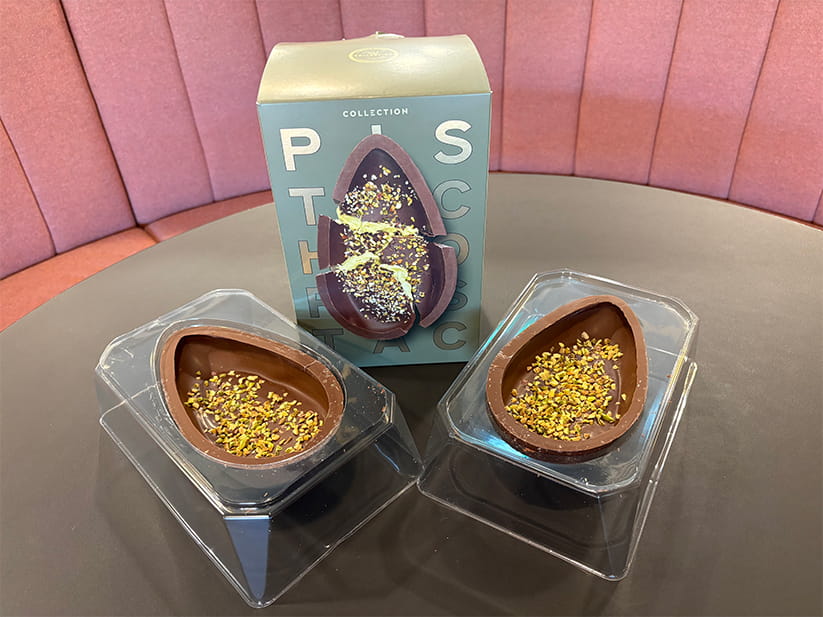 Both halves of a M&S Pistachio Easter egg laid out with its packaging