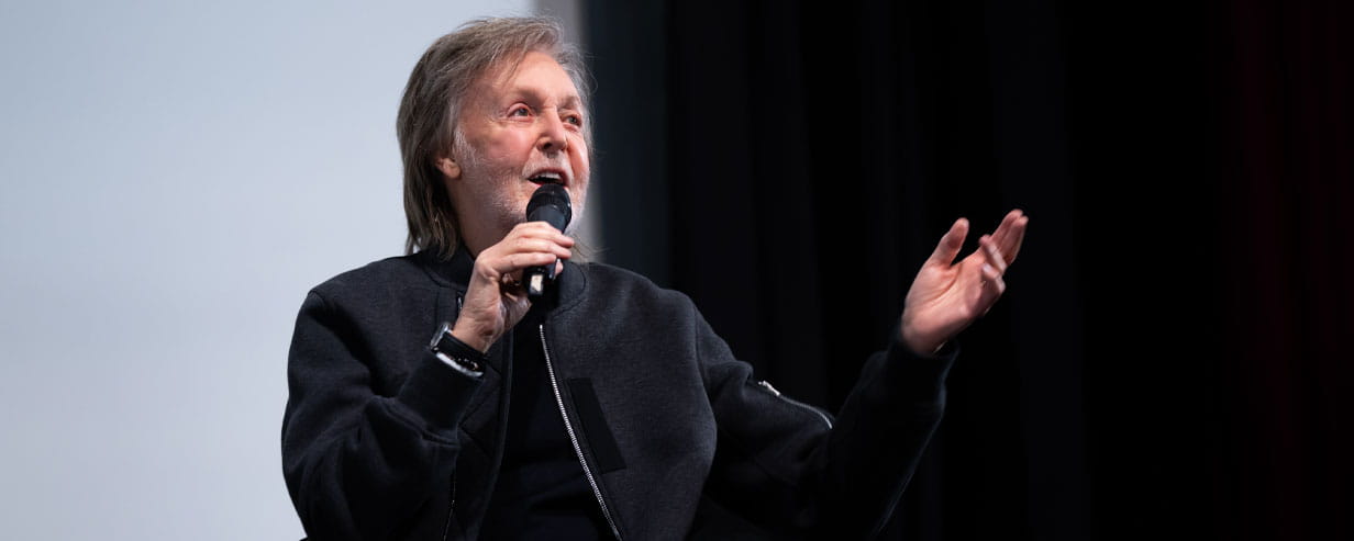 Paul McCartney on stage with a microphone