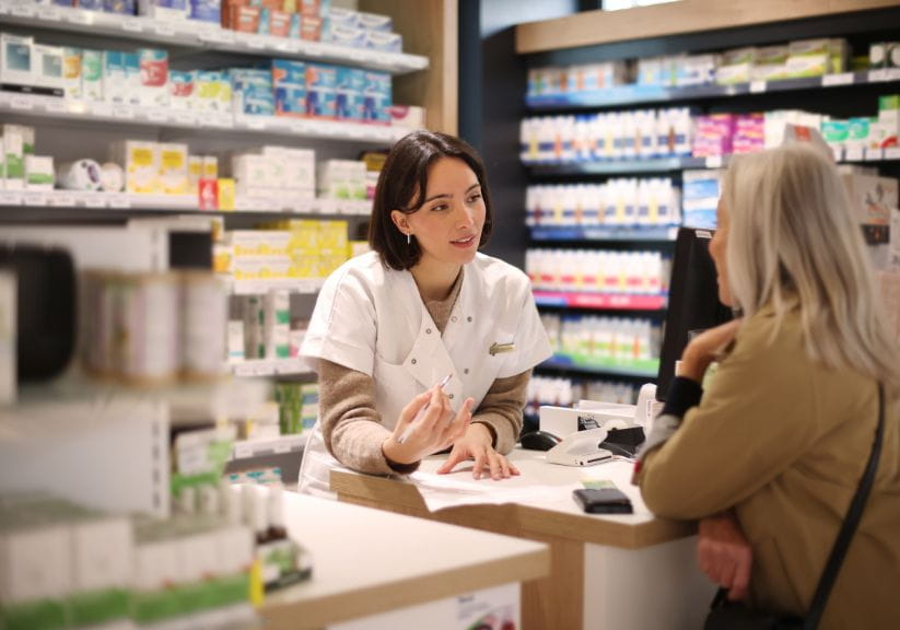 A pharmacist gives a customer advice