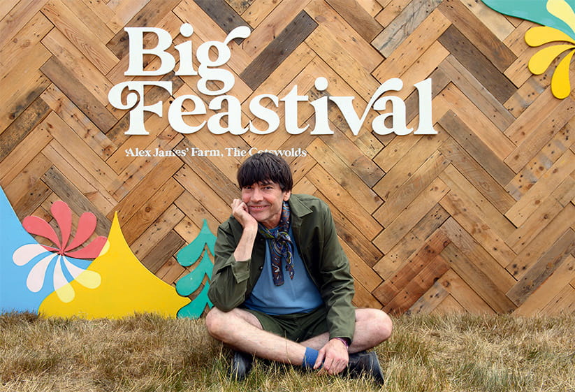 Alex James sitting on the grass at the Big Feastival