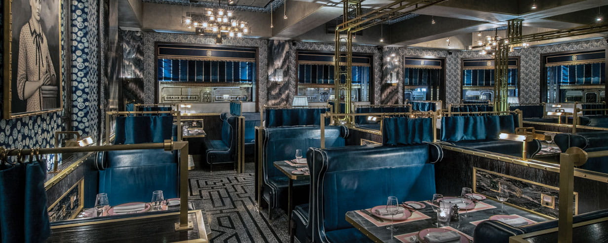 The interior of the Bob Bob Ricard restaurant in Soho luxuriously decorated with blue leather booths and bronze trimming