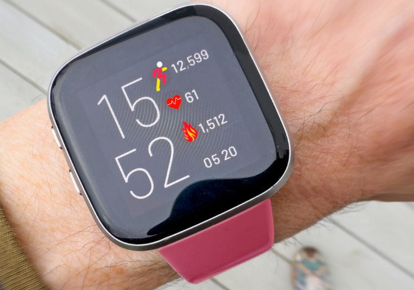 A close up of a smart watch screen showing vital statistics such as steps, heart rate