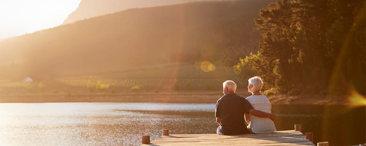 couple sitting on the end of a jetty