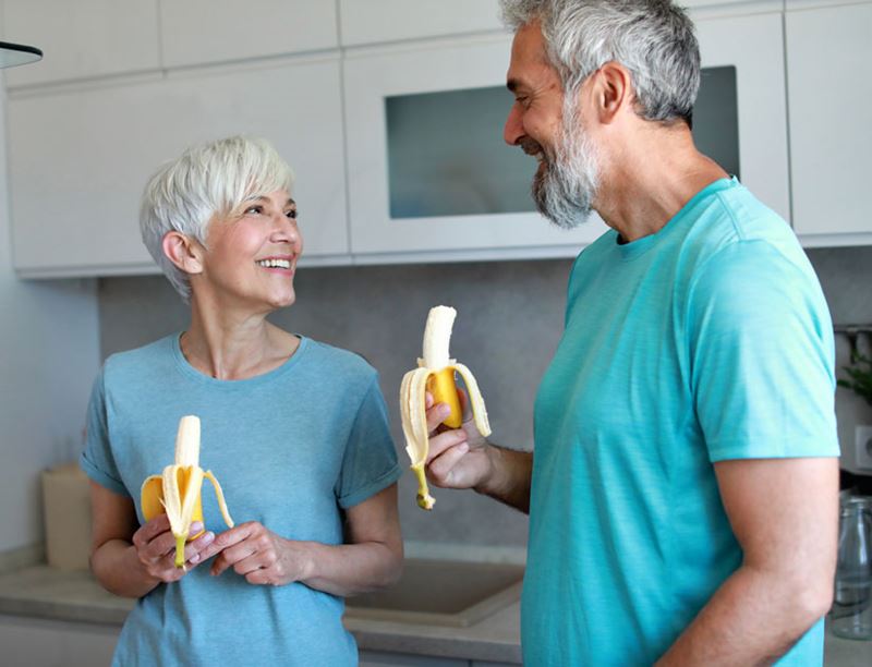 Portrait of a senior mature couple having a healthy breakfast after fitness exercise training in the morning at home