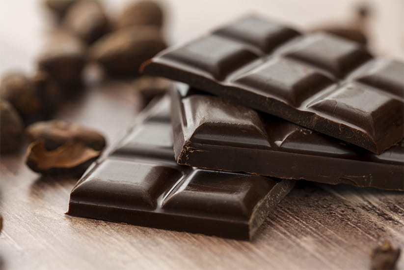 Gourmet and appetizing dark chocolate bar with cocoa beans
