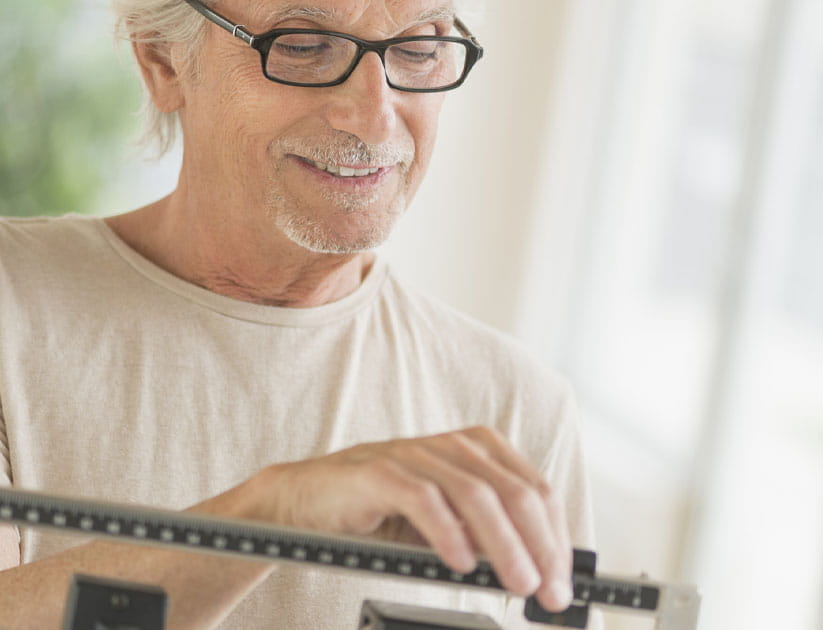 Senior man on weight scale