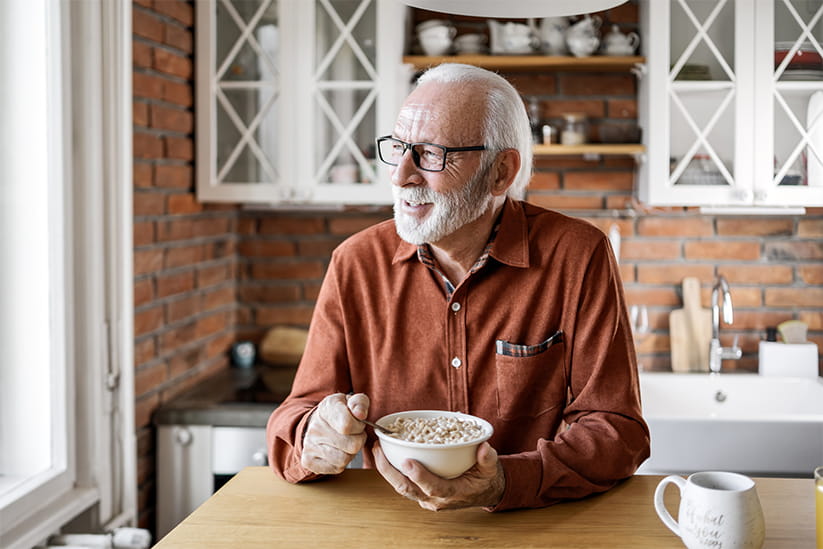 Gray Bearded Man Enjoying Cereal in Cozy Kitchen