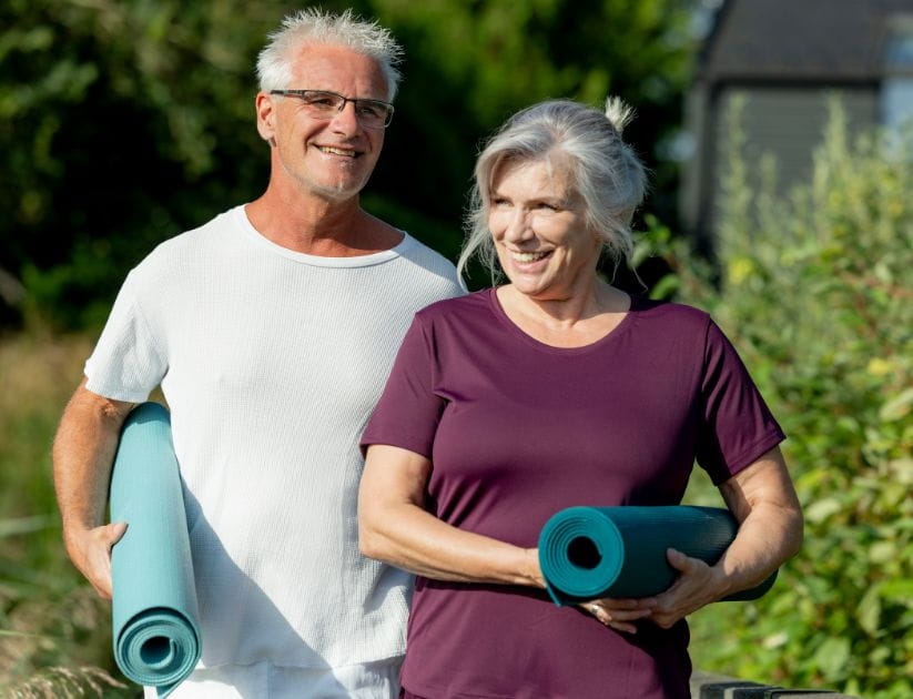 Man and woman with yoga mats